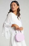 mini hard-shell bag is a fluro shade of lilac