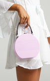 mini hard-shell bag is a fluro shade of lilac
